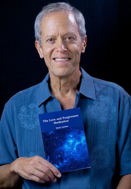 Mark Landau holding his book