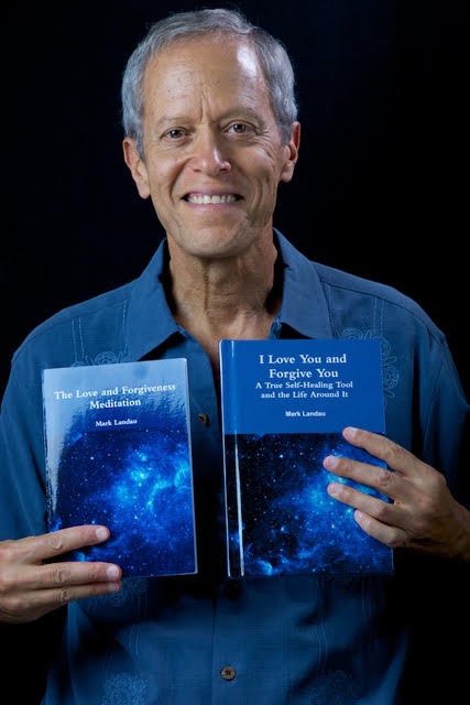 Mark Landau holding his books